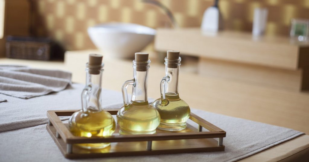 drei Fläschchen Öl stehen im Badezimmer